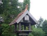 bird table with tiled roof and gargoyle finial thumb