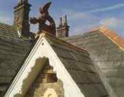 roof dragon on a slate roof with terracotta ridge tiles